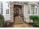 Welcoming front entrance with brick steps, stone accents, and a decorative wreath on the front door at 8405 Hempton Cross Dr, Wake Forest, NC 27587