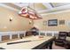Basement game room featuring a pool table, bar, and unique sports lighting fixture at 8405 Hempton Cross Dr, Wake Forest, NC 27587