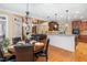 Open kitchen and dining area features hardwood floors, modern lighting, and stainless steel appliances at 8405 Hempton Cross Dr, Wake Forest, NC 27587