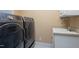 A modern laundry room with large appliances and a utility sink at 8405 Hempton Cross Dr, Wake Forest, NC 27587