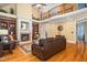 Inviting living room with a fireplace, soaring ceilings, and elegant hardwood floors at 8405 Hempton Cross Dr, Wake Forest, NC 27587