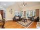 Spacious living room with hardwood floors, large windows, and access to the dining area at 8405 Hempton Cross Dr, Wake Forest, NC 27587