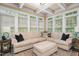 Inviting living room offers a comfortable sectional sofa, coffered ceiling, and plenty of natural light at 8405 Hempton Cross Dr, Wake Forest, NC 27587