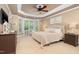 Relaxing main bedroom with plush carpet, bay window, and tray ceiling with fan at 8405 Hempton Cross Dr, Wake Forest, NC 27587