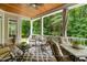 Inviting covered porch with a ceiling fan, comfortable seating, and wooded views at 8405 Hempton Cross Dr, Wake Forest, NC 27587