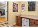 Wet bar featuring a sink, mini fridge, and wooden cabinets at 8405 Hempton Cross Dr, Wake Forest, NC 27587