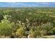 Beautiful aerial view of a tree-surrounded home with a long driveway and lush forest around the land at 852 Fred Wilder Rd, Franklinton, NC 27525