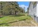 Large backyard showing a tree line, maintained lawn, home's exterior, and AC unit at 852 Fred Wilder Rd, Franklinton, NC 27525