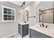 A bright bathroom features double sinks with elegant fixtures and marble countertops at 852 Fred Wilder Rd, Franklinton, NC 27525