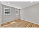 A bright bedroom features LVP flooring, neutral walls, and two windows at 852 Fred Wilder Rd, Franklinton, NC 27525