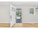 Bright entryway with a view of the front yard through the glass pane front door and side window at 852 Fred Wilder Rd, Franklinton, NC 27525