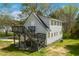 Rear exterior view of the home highlighting the multiple decks, stairs, and well-kept lawn at 852 Fred Wilder Rd, Franklinton, NC 27525