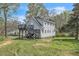 Exterior view showcasing the multiple decks, gray siding, and well-maintained yard of the home at 852 Fred Wilder Rd, Franklinton, NC 27525