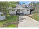 Charming two-story home featuring a gray metal roof and covered porch with black trim at 852 Fred Wilder Rd, Franklinton, NC 27525