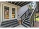 Stairway leading up to the deck, complemented by glass panel french doors and natural lighting at 852 Fred Wilder Rd, Franklinton, NC 27525