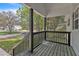Charming front porch featuring black railings, rustic wood flooring, and views of the surrounding yard and street at 852 Fred Wilder Rd, Franklinton, NC 27525
