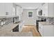 Modern kitchen featuring white cabinetry, black appliances, and granite countertops at 852 Fred Wilder Rd, Franklinton, NC 27525