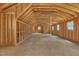 Large unfinished room, framed and ready for customization, featuring multiple windows and ample space at 852 Fred Wilder Rd, Franklinton, NC 27525
