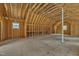 Spacious unfinished room with exposed wood beams, offering a blank canvas for creative design at 852 Fred Wilder Rd, Franklinton, NC 27525