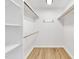 The white, walk-in closet has LVP floors and wooden clothes rods at 852 Fred Wilder Rd, Franklinton, NC 27525