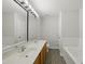 Spacious bathroom with double sinks, a tiled floor, and a large mirror at 8621 Neuse Club Ln # 106, Raleigh, NC 27616