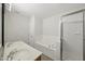 Bathroom with a double sink vanity, separate tub, and glass-enclosed shower at 8621 Neuse Club Ln # 106, Raleigh, NC 27616
