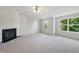 Spacious bedroom featuring a modern fireplace, neutral walls, and a bright window view at 8621 Neuse Club Ln # 106, Raleigh, NC 27616
