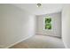 Cozy bedroom with neutral walls, plush carpet and a bright window view at 8621 Neuse Club Ln # 106, Raleigh, NC 27616