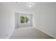 Spacious bedroom features neutral walls, plush carpeting, and a bright window view at 8621 Neuse Club Ln # 106, Raleigh, NC 27616