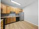 Bright kitchen featuring wooden cabinets, modern appliances, and sleek backsplash at 8621 Neuse Club Ln # 106, Raleigh, NC 27616