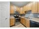 Modern kitchen features wooden cabinets, stainless steel appliances, and tiled backsplash at 8621 Neuse Club Ln # 106, Raleigh, NC 27616
