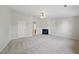 Open concept living room with neutral carpet and a cozy fireplace at 8621 Neuse Club Ln # 106, Raleigh, NC 27616