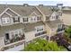 Aerial view of townhomes with light exteriors and private balconies at 9164 Wooden Rd, Raleigh, NC 27617