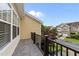 A railed balcony offers an outdoor space with views of the surrounding neighborhood at 9164 Wooden Rd, Raleigh, NC 27617