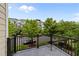 This balcony features tiled floor and a black metal railing offering views of the community at 9164 Wooden Rd, Raleigh, NC 27617