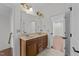 Dual sinks, granite counter tops, and excellent lighting define the inviting bathroom at 9164 Wooden Rd, Raleigh, NC 27617