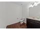 Bathroom features hardwood floors, vanity, and commode at 9164 Wooden Rd, Raleigh, NC 27617