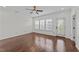 A bright, empty bedroom space offers hardwood floors, natural light, and a ceiling fan at 9164 Wooden Rd, Raleigh, NC 27617