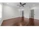A well lit bedroom featuring hardwood flooring, a modern ceiling fan, and easy access to a closet at 9164 Wooden Rd, Raleigh, NC 27617