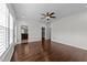 Spacious bedroom boasts hardwood flooring, plantation shutters, ceiling fan, and ensuite bathroom and walk-in closet at 9164 Wooden Rd, Raleigh, NC 27617