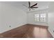 This well-lit bedroom includes beautiful hardwood flooring and a modern ceiling fan at 9164 Wooden Rd, Raleigh, NC 27617