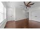 This bedroom offers an abundance of space, natural light, and attractive dark wood floors at 9164 Wooden Rd, Raleigh, NC 27617