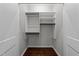 Walk-in closet with built-in shelving and hardwood floors at 9164 Wooden Rd, Raleigh, NC 27617