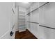 Walk-in closet with custom shelves and a rod for hanging clothes at 9164 Wooden Rd, Raleigh, NC 27617