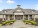 Inviting clubhouse with stone accents, manicured landscaping, and covered entry for residents at 9164 Wooden Rd, Raleigh, NC 27617