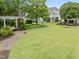 Expansive green common area with seating, landscaping, and community buildings in the background at 9164 Wooden Rd, Raleigh, NC 27617