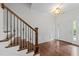 Elegant foyer with hardwood floors, decorative molding, a wooden staircase, and a stylish light fixture at 9164 Wooden Rd, Raleigh, NC 27617