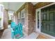 Inviting front porch featuring a brick facade, ample natural light, and cozy Adirondack chairs for relaxing at 9164 Wooden Rd, Raleigh, NC 27617