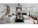 Staged living room featuring a fireplace, hardwood floors, and an area rug at 9164 Wooden Rd, Raleigh, NC 27617