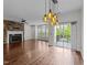 Spacious living room with a cozy fireplace, recessed lighting, hardwood floors, and access to a private balcony at 9164 Wooden Rd, Raleigh, NC 27617